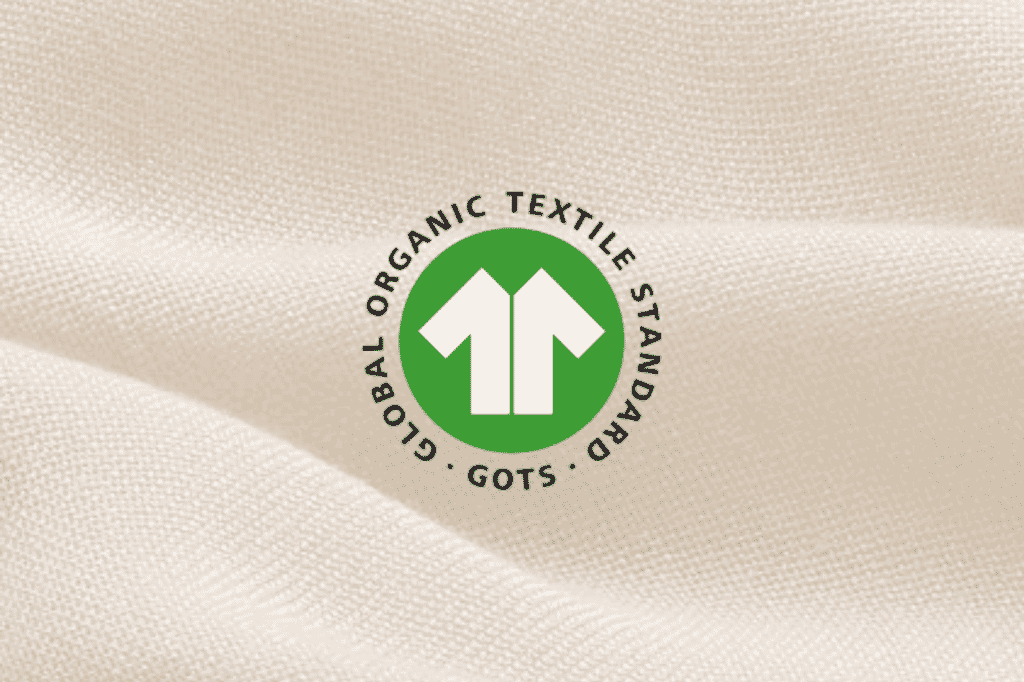 What Is GOTS Certification for Textiles and Why Should You Care? - Orchids Lux Home Close-up of the GOTS logo on fabric showing GOTS certification for organic textile products.