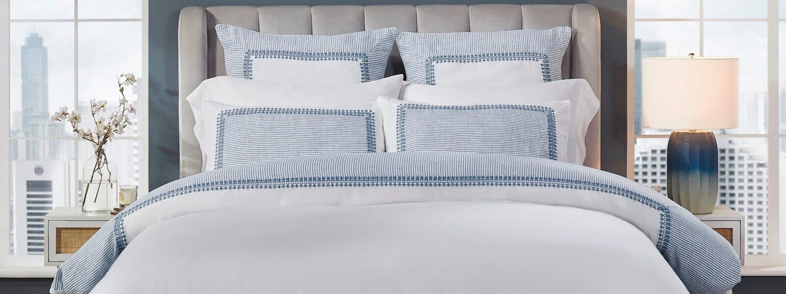Elegant bedroom styled with crisp white and blue bedding made from premium European Linen. Soft textures and breathable fabric create a refined, hotel-inspired sleeping space.