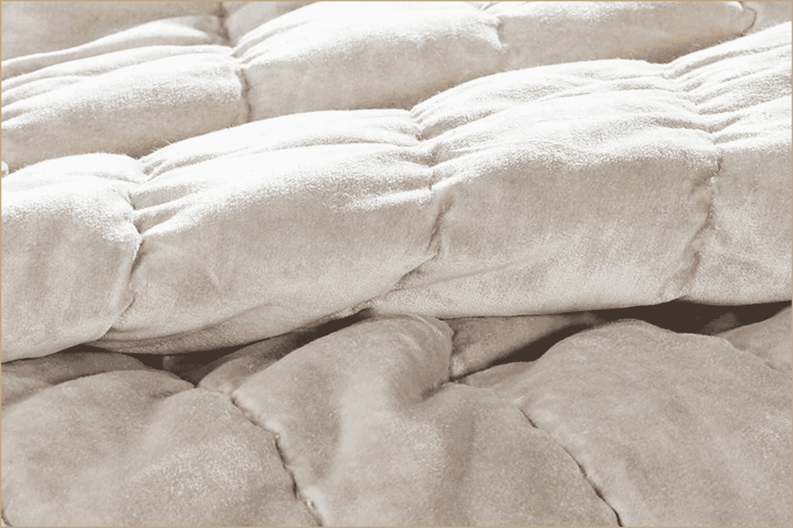 Close-up of a velvet quilt showing plush, raised quilting and soft sheen.