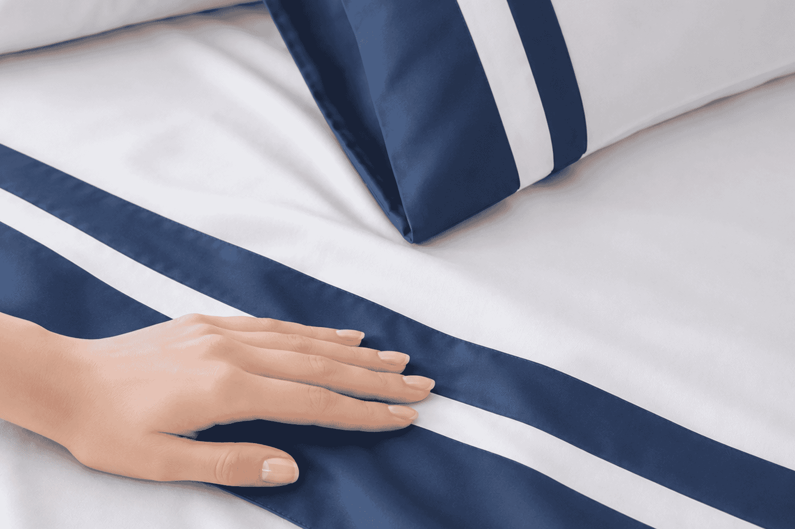 Orchids Lux Home review highlighting smooth white bedding with navy satin border detailing.